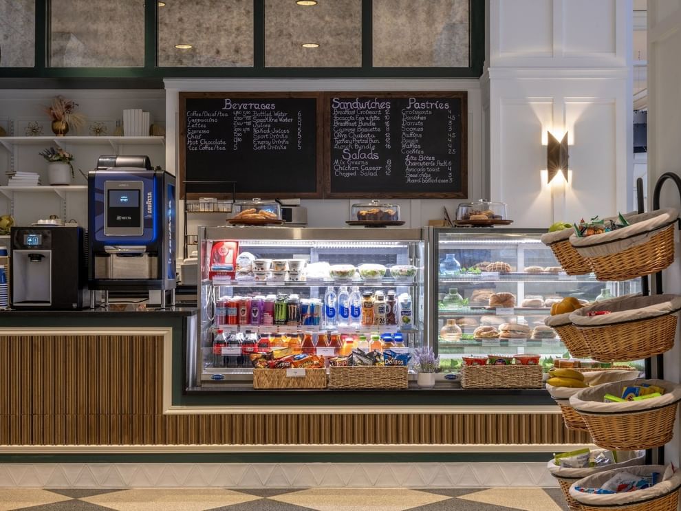 Beverage and pastry display cases with snacks in baskets at Allerton Cafe and Lounge in Warwick Allerton Chicago 
