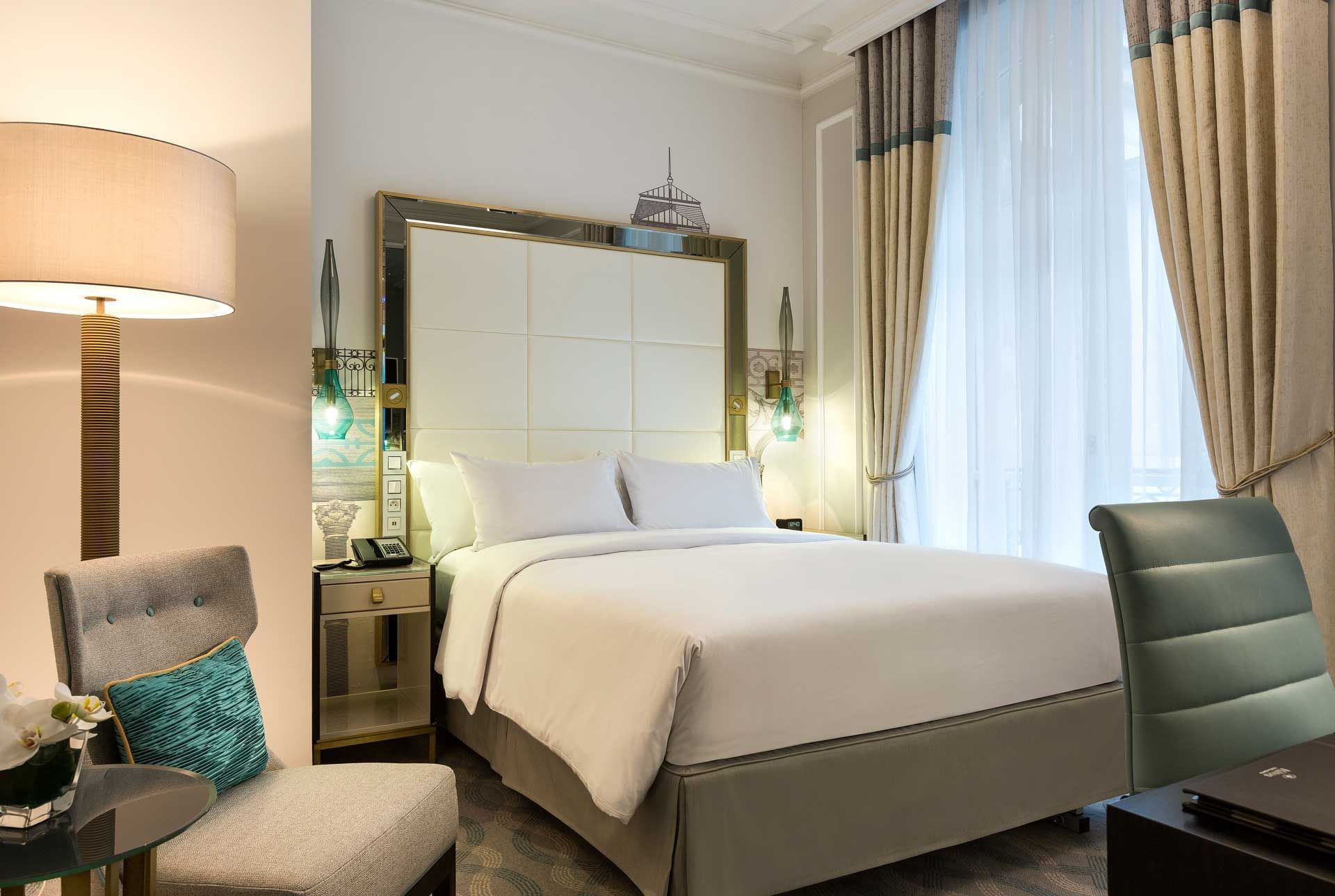 Bed & furniture in Deluxe Room at Hilton Paris Opera Hotel