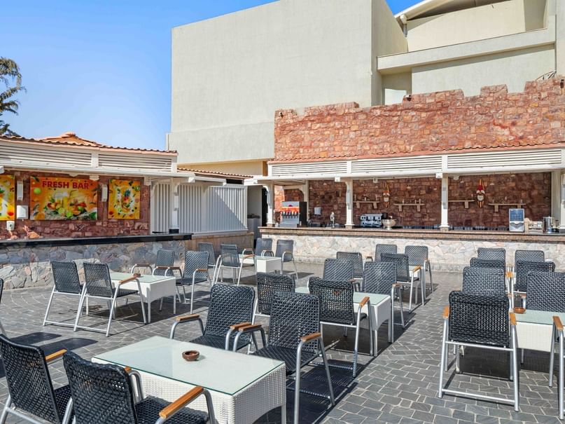 Outdoor seating area with tables and chairs at Castello Bar in Hurghada at Pickalbatros Dana Beach Resort.