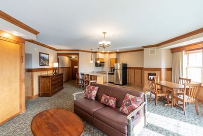 Grandview Suite at Lake Placid Club Grandview features a leather couch, dining area, and a kitchenette with bar seating