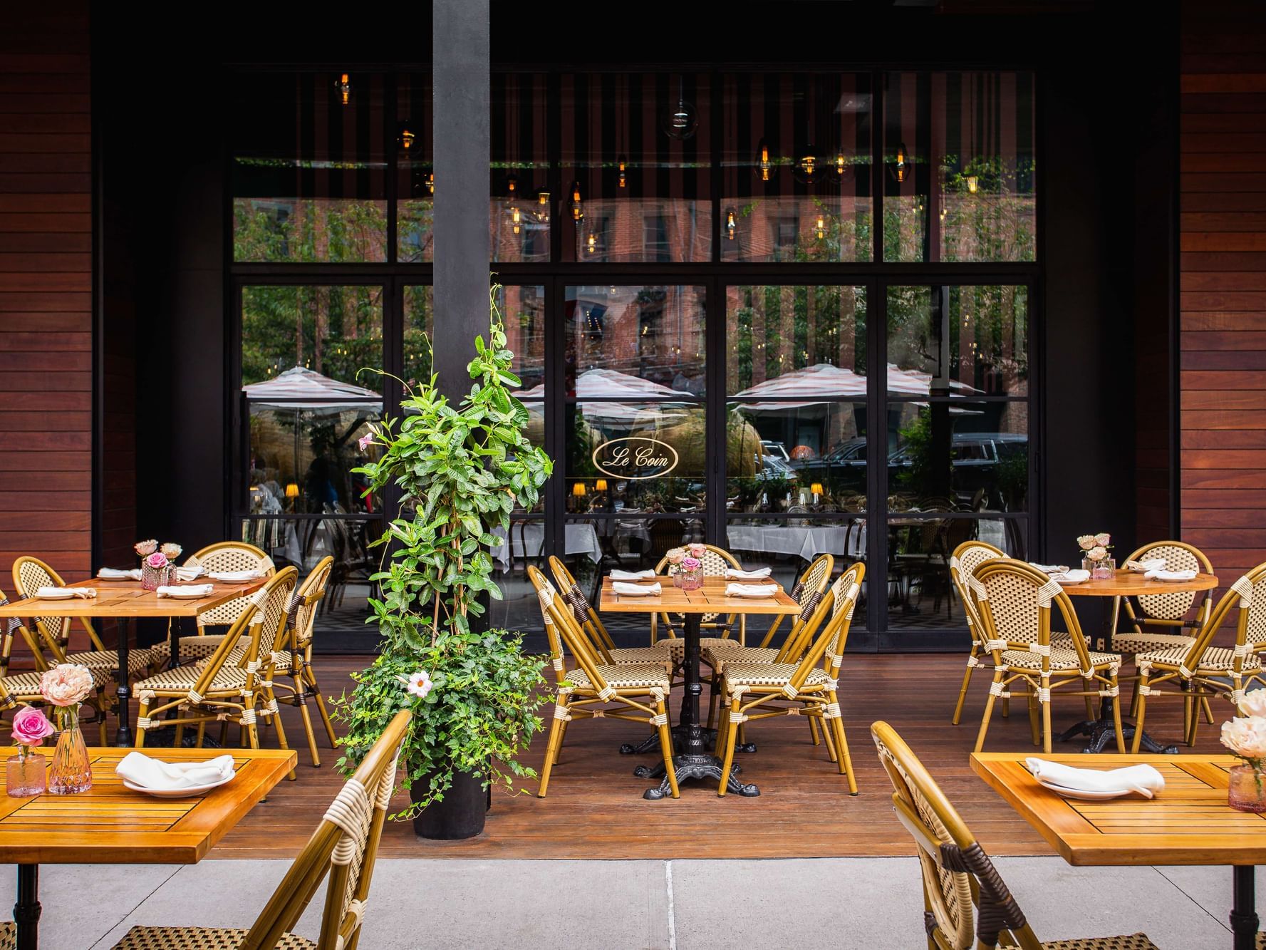 Exterior patio of Le Coin with tables