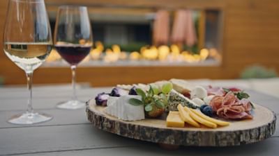 Wine glasses & charcuterie board on a table at The Nest