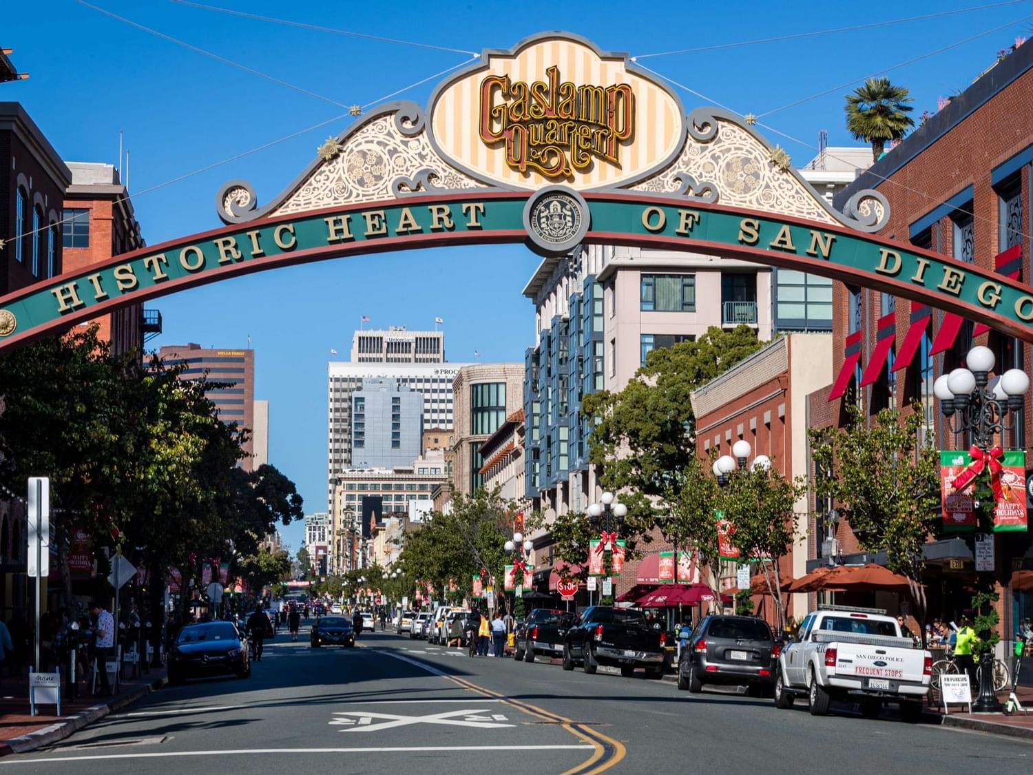 Gaslamp Quarter arch at San Diego over a busy street with buildings and cars near Horton Grand Hotel