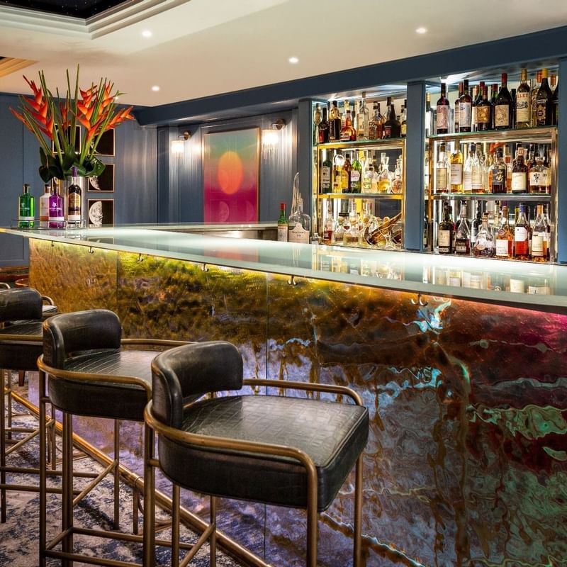Bar counter with botels of shelves in The Restaurant at The Capital