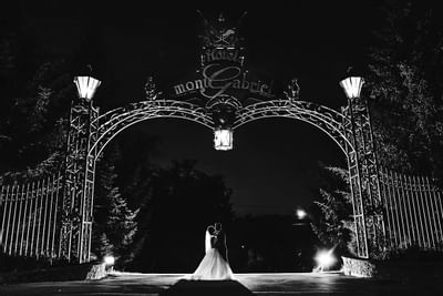 B&W snap of a couple at entrance of Hotel Mont Gabriel Resort