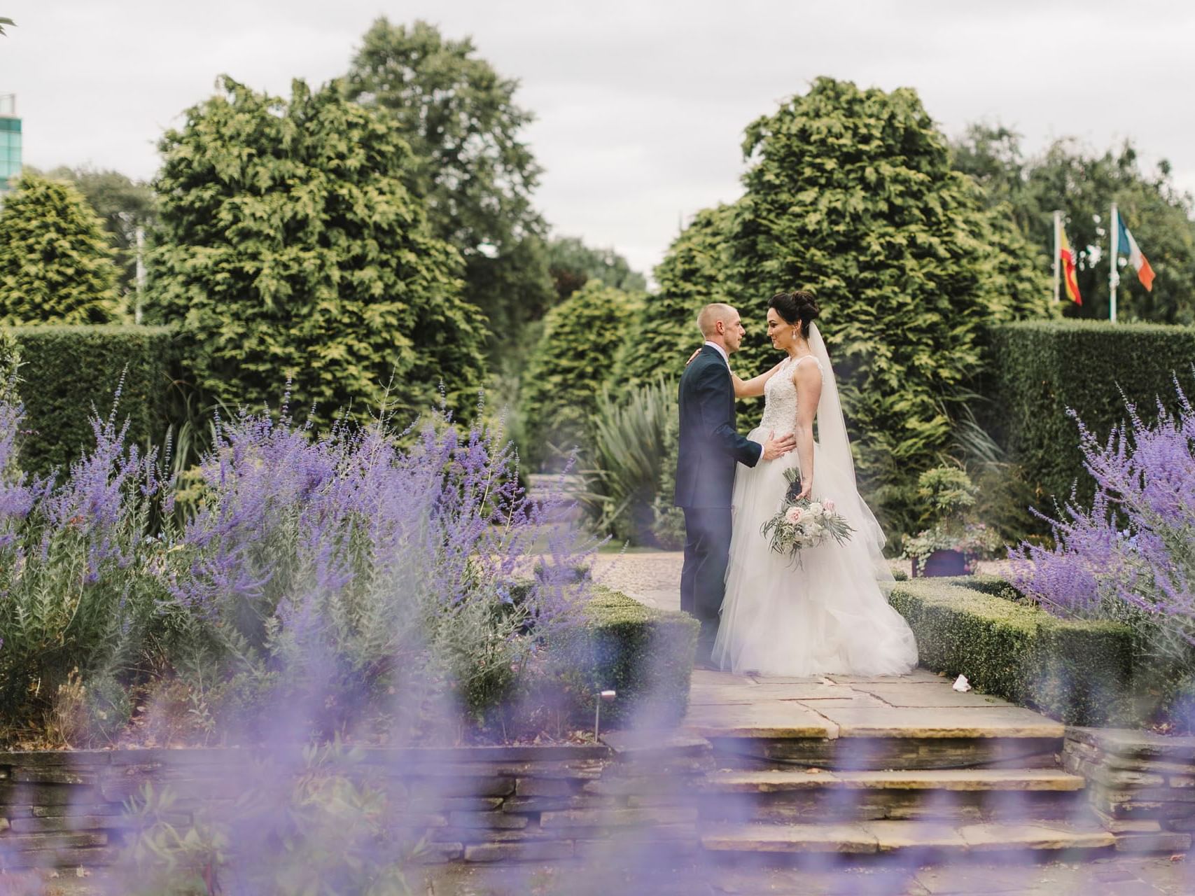 Bride and groom standing in a garden pathway at The Milner York featuring The Royal York Wedding Package