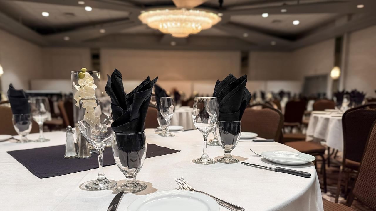 Elegantly set banquet table with glassware and napkins.