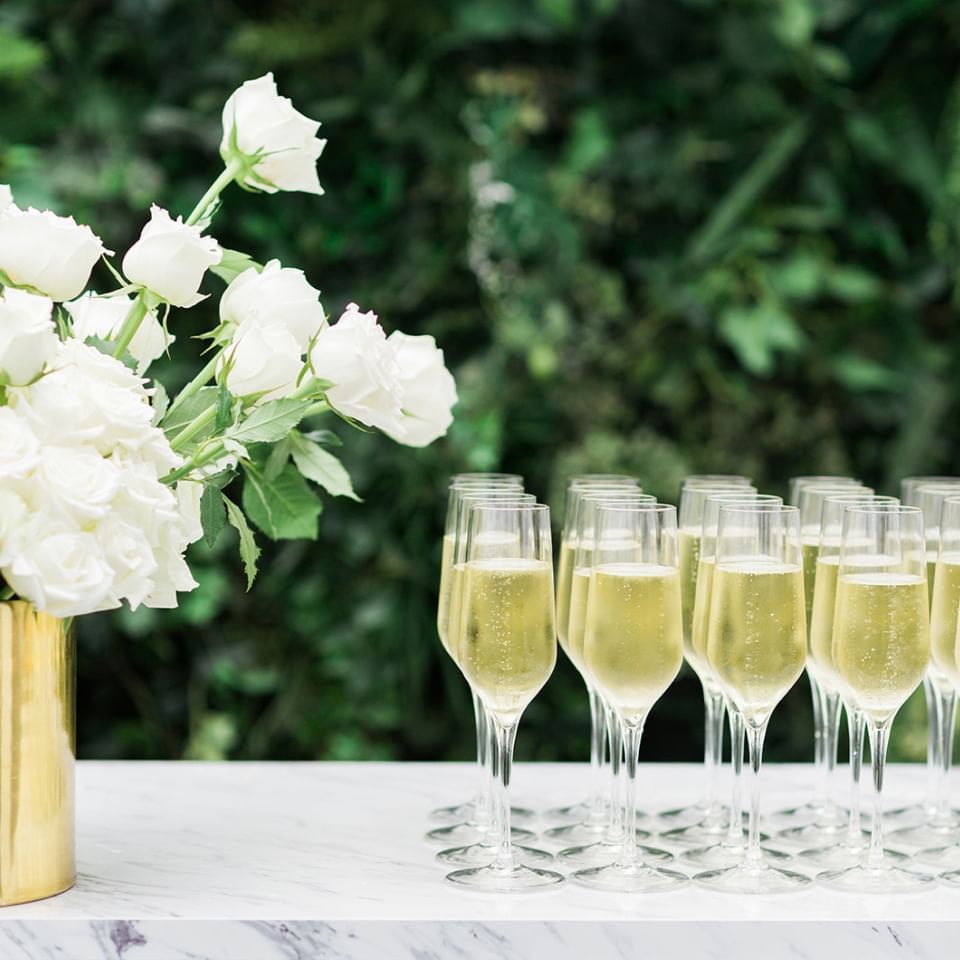 Vase of roses and wine glasses setup at Crown Hotel Melbourne