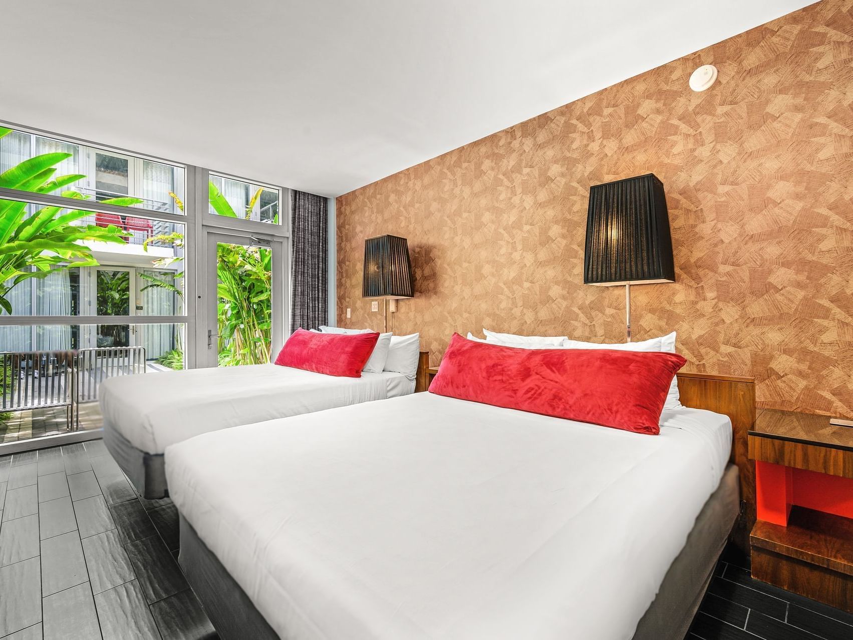 Double beds with nightstands by the window in Garden Deluxe Double at Fairwind Hotel Miami