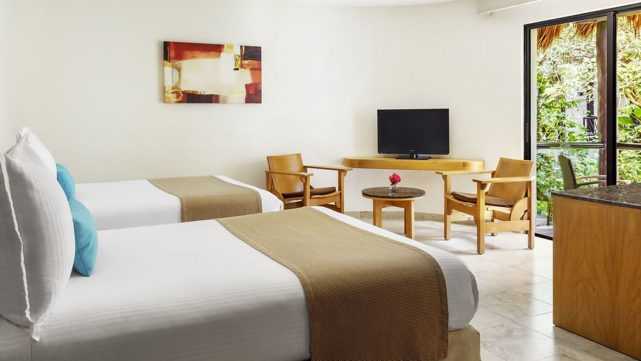 Two beds and TV in Superior room at The Reef Playacar