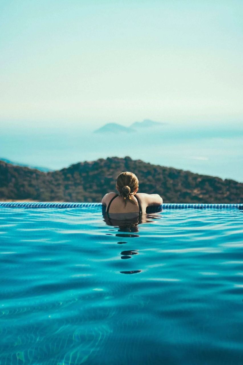 Person relaxing in an infinity pool at The Terraces Resort & Spa