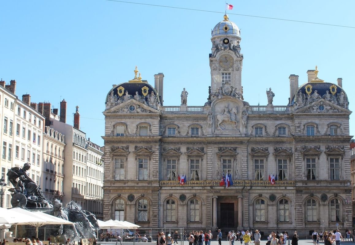 The historic Hôtel de Ville and Bartholdi Fountain at Place des Terreaux near Warwick Lyon