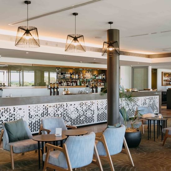 Cozy chairs arranged in Shallows Bar at Pullman Magenta Shores Resort