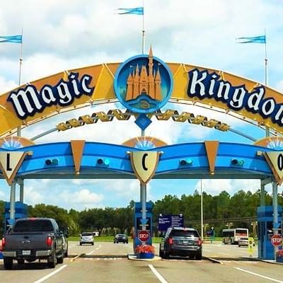 cars driving through the entrance to Magic Kingdom