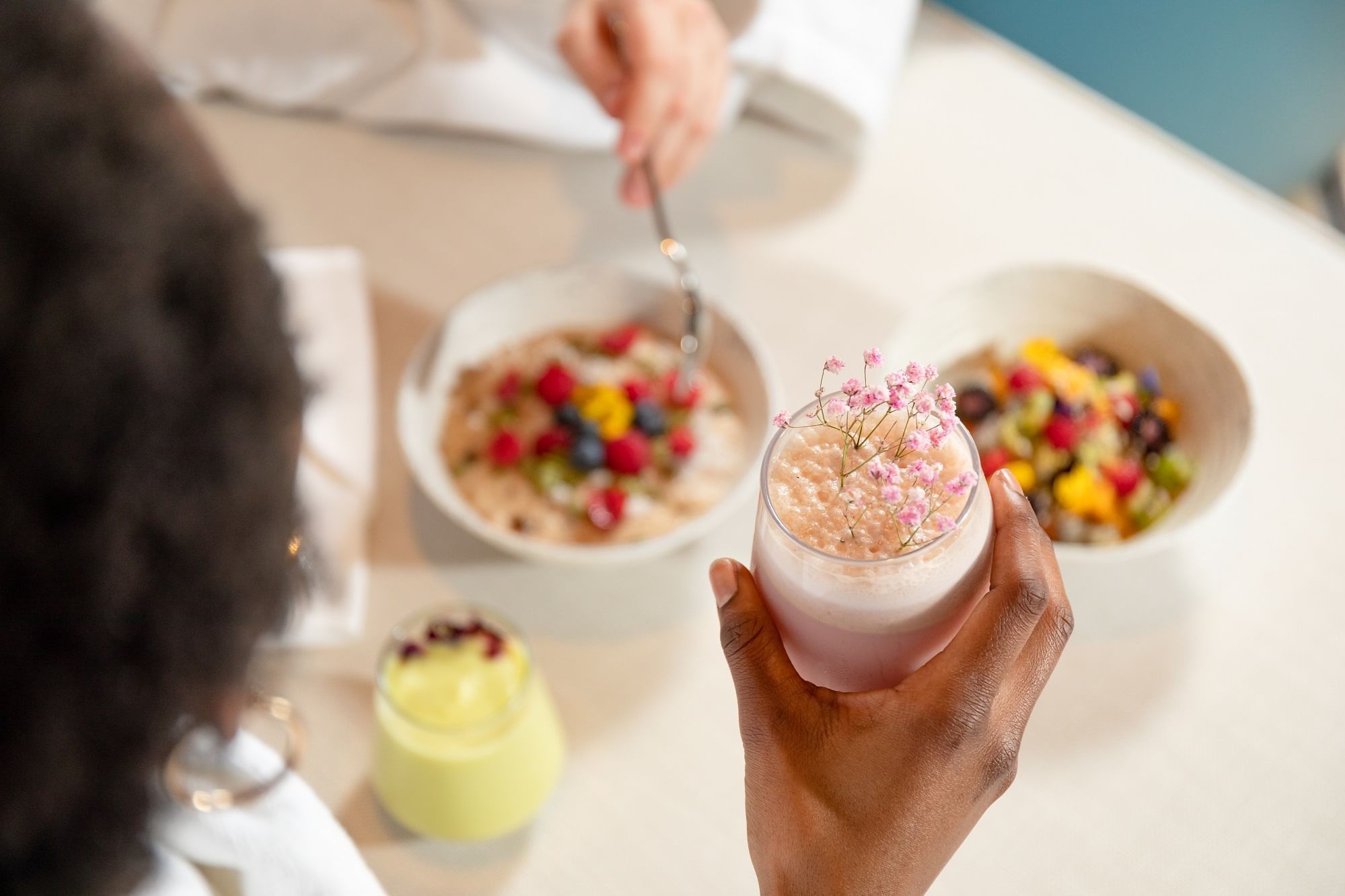 Close-up of couple having cereal & smoothies at The Londoner