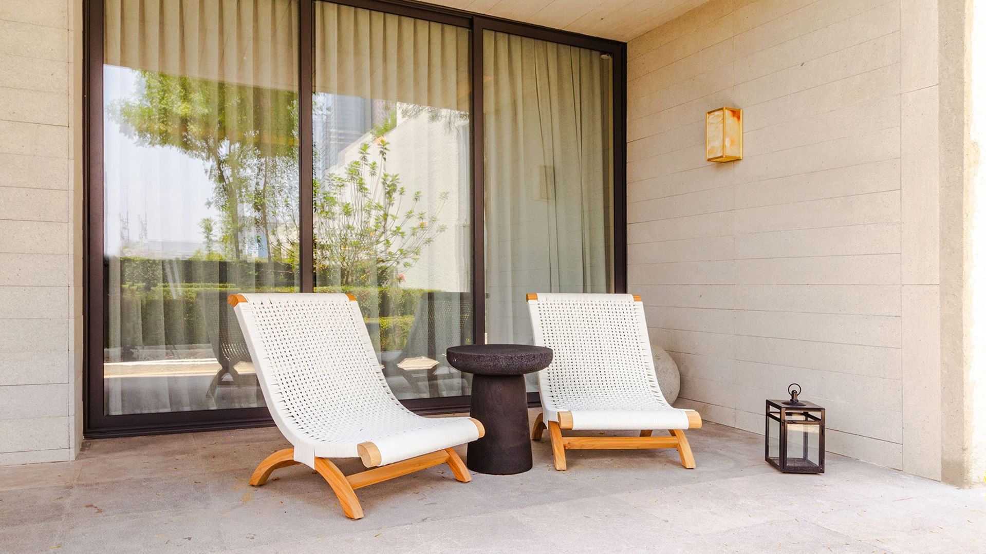 King Superior Viceroys Suite outdoor terrace featuring white lounge chairs and a side table at Camino Real Polanco Mexico