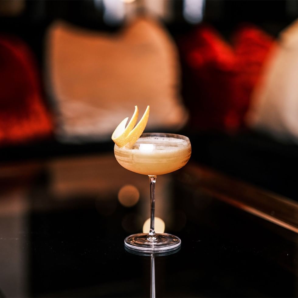 Cocktail with lemon slices on a black table for Cocktail Masterclass.