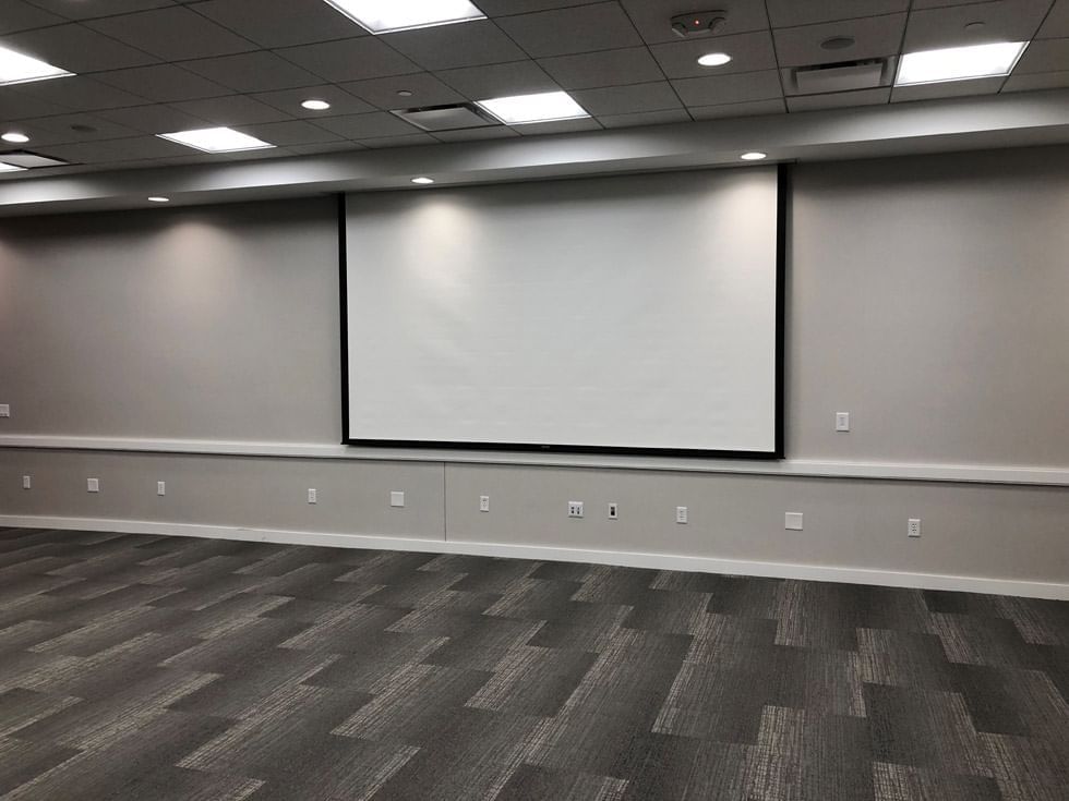 Projector screen in Cardinal & Gold Room at Gateway Hotel Ames