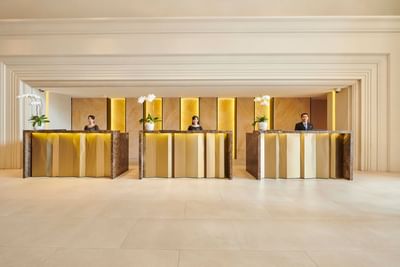 Three receptionists working at the front desk at Eastin Grand Hotel Saigon