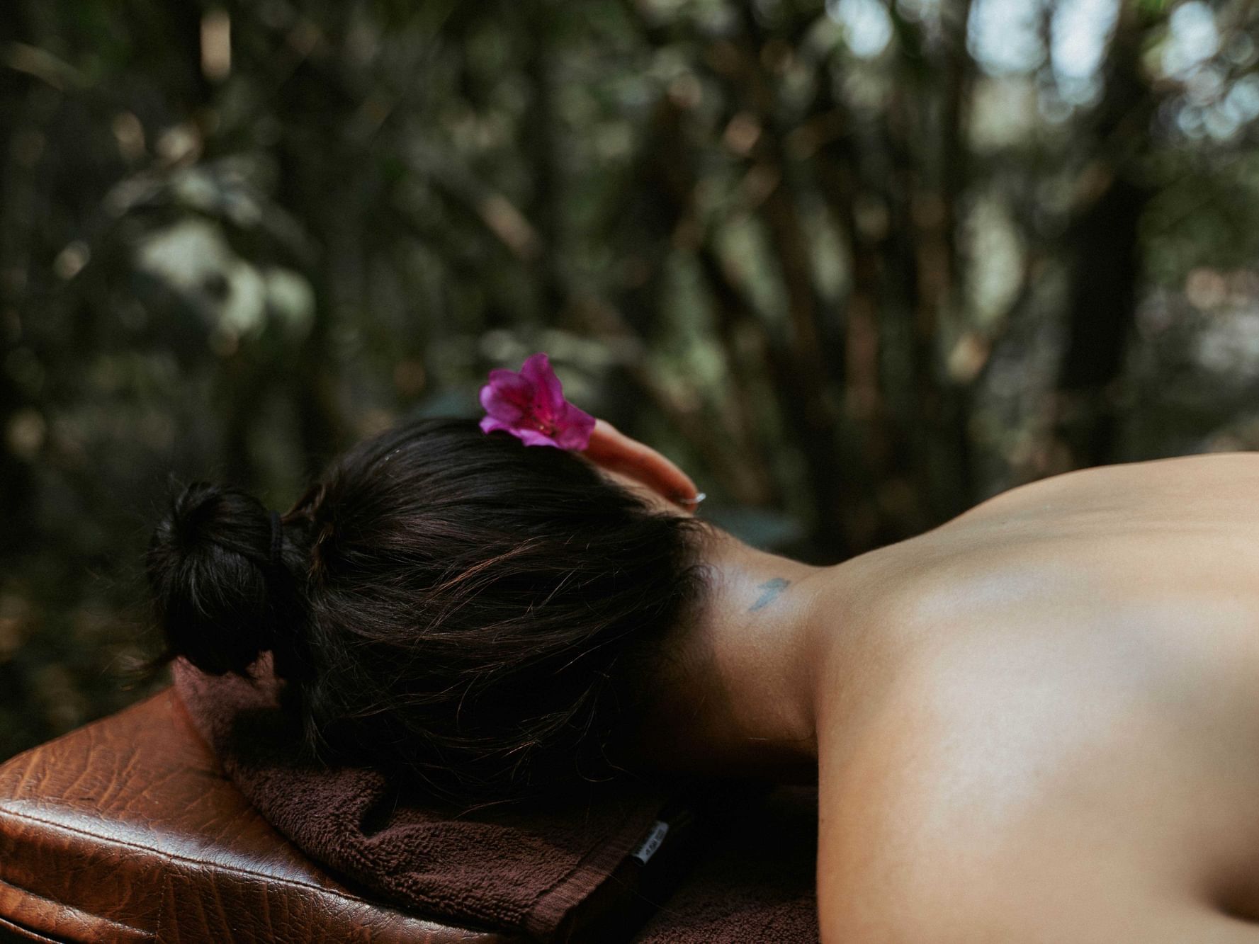 Man and a woman practicing yoga in a wooded setting at Dwarika's Himalayan Wellbeing