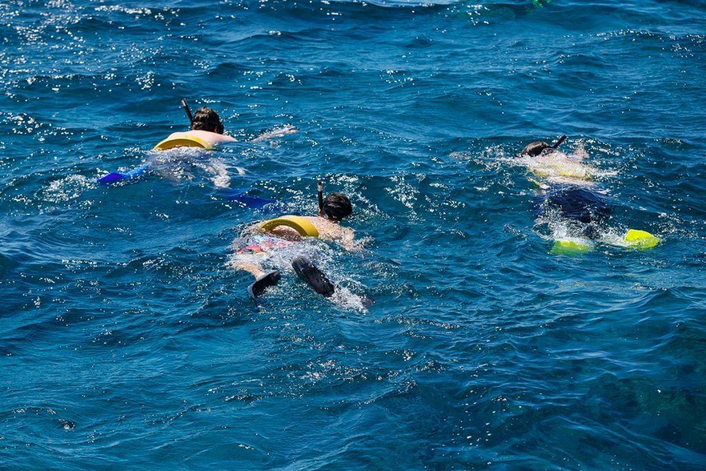 Kids snorkeling in the sea at The Somerset on Grace Bay