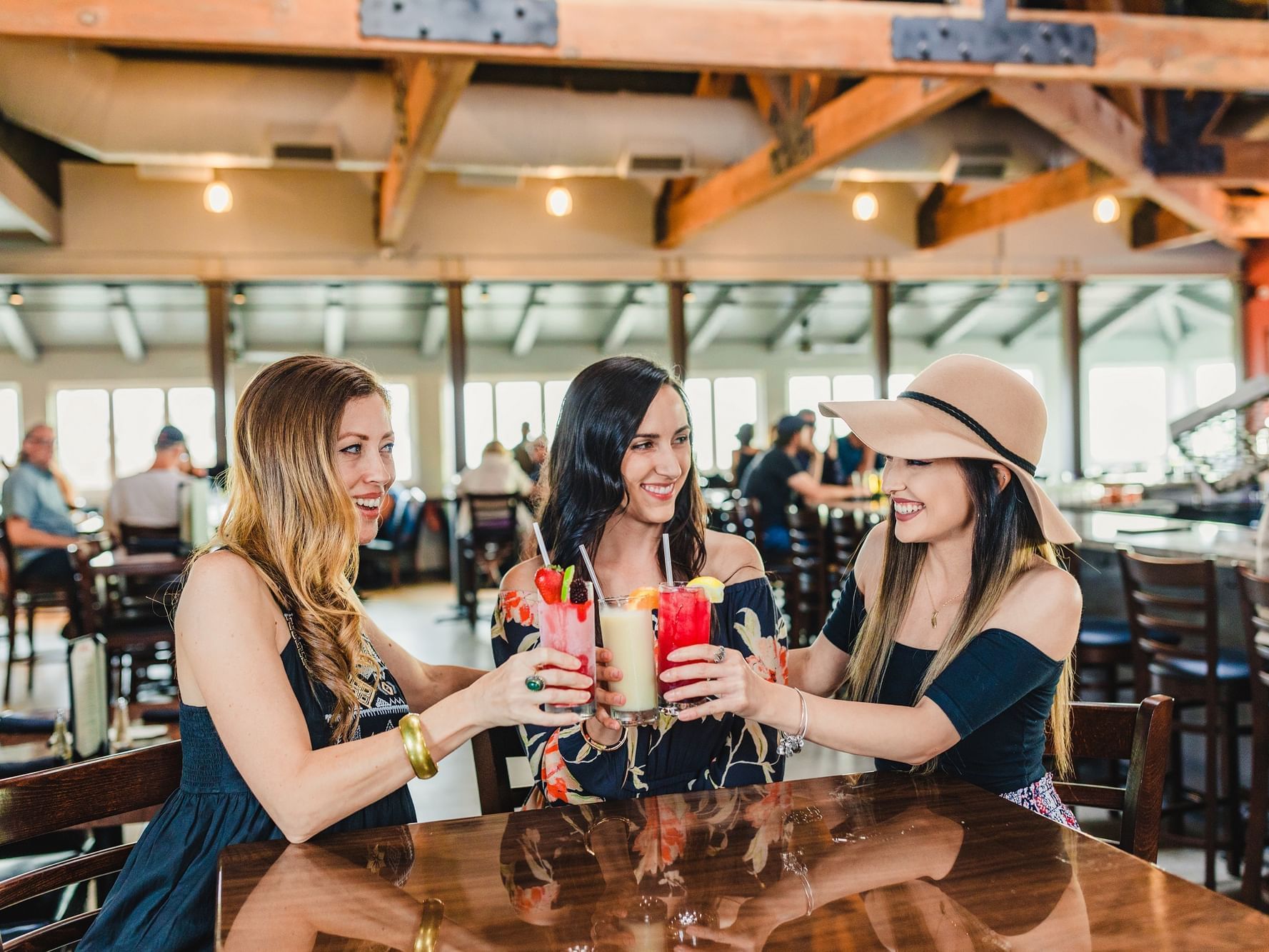Three ladies enjoying cocktails at a restaurant table