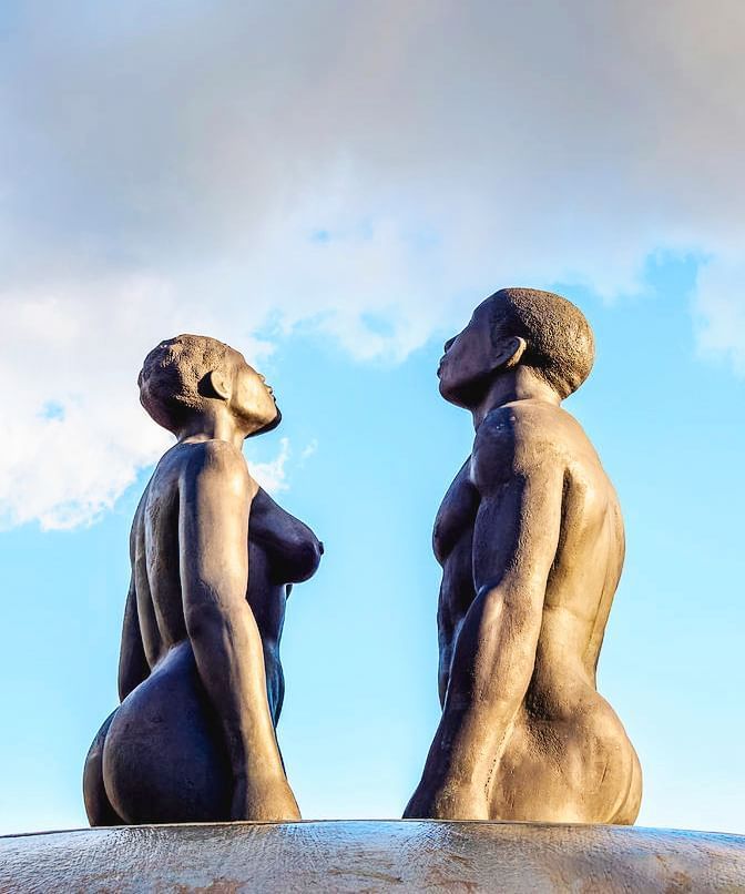 Two statues facing each other near Jamaica Pegasus Hotel