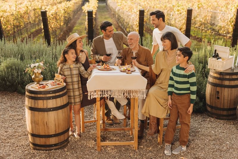 A family enjoying outdoors while having wine at Fiesta Americana Travelty