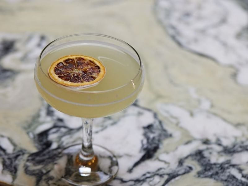 Cocktail with dried citrus garnish served in Modo Mio at Crown Promenade Perth