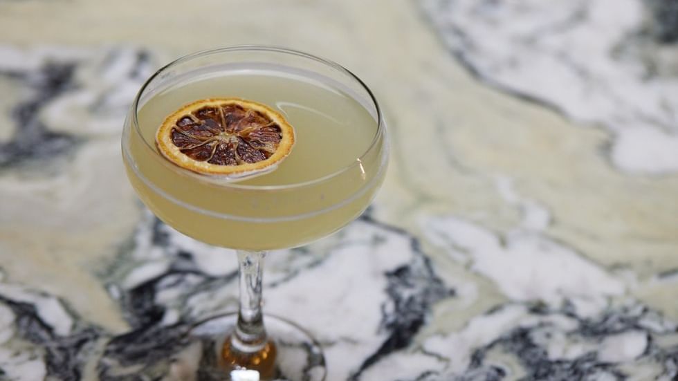 Cocktail with dried citrus garnish served in Modo Mio at Crown Promenade Perth