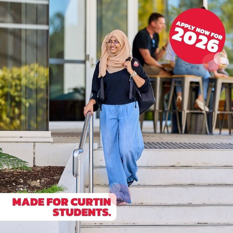 Woman in hijab walking down stairs with 