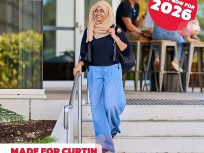 Woman in hijab walking down stairs with 