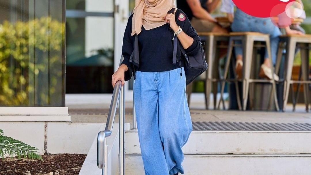 Woman in hijab walking down stairs with 