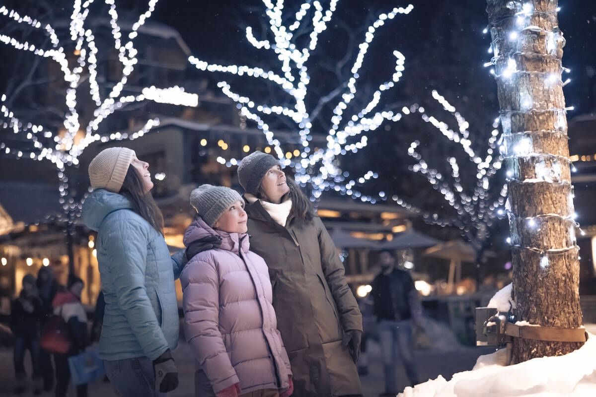 People exploring lights by trees near Blackcomb Springs Suites