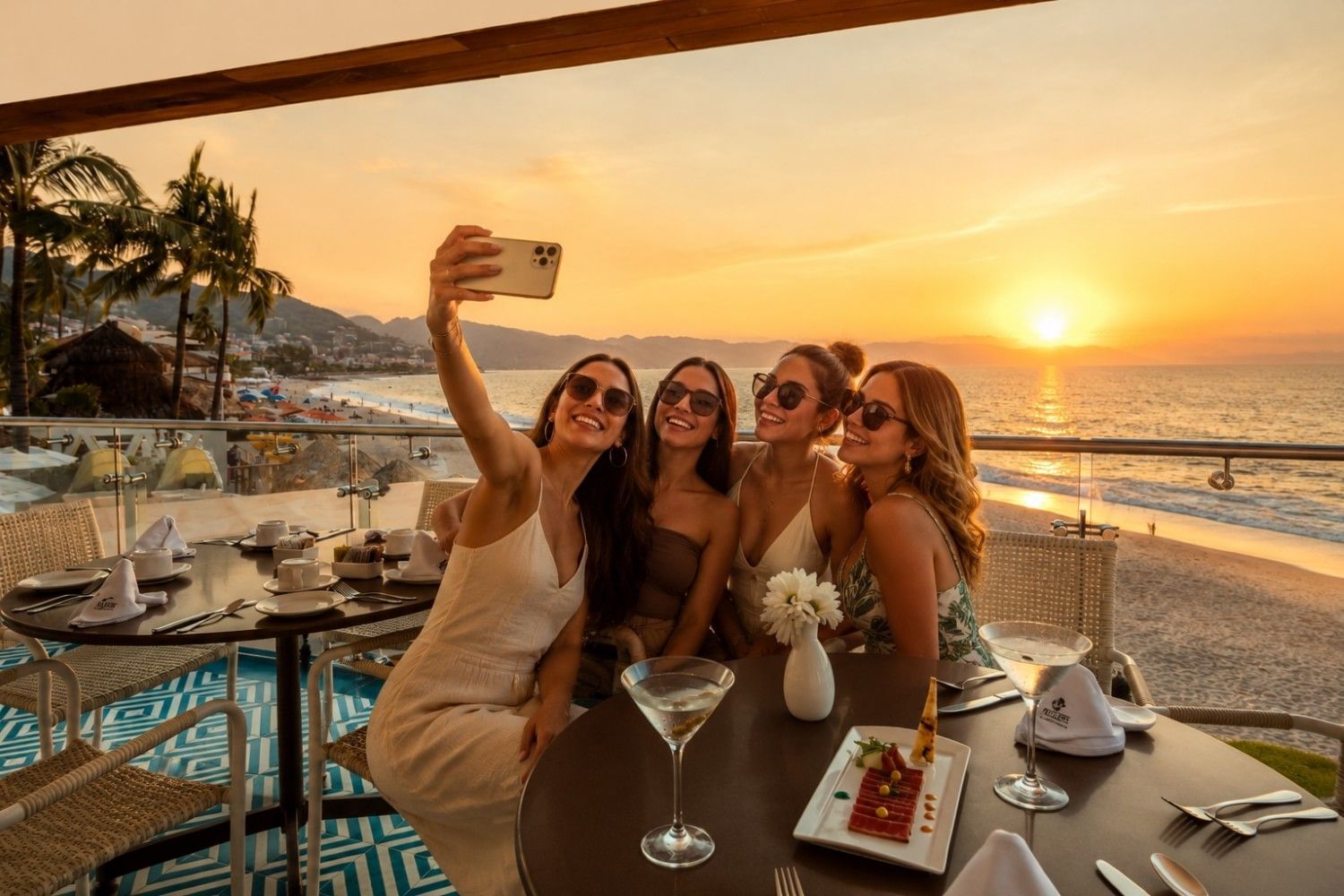 Four friends taking a sunset selfie on an oceanfront terrace at Villa Premiere Boutique Hotel during a Puerto Vallarta girls trip.