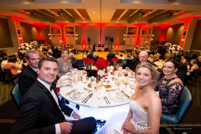 a bride and groom sitting with their family