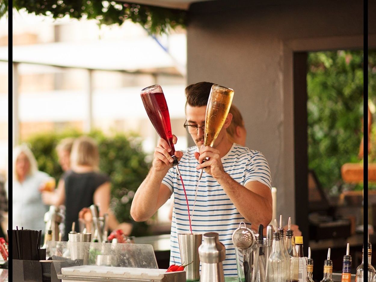 Man holding two drinks bottle at Pullman & Mercure Brisbane King George Square