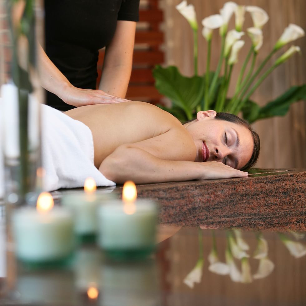 Woman getting a massage in a spa at Falkensteiner Hotels