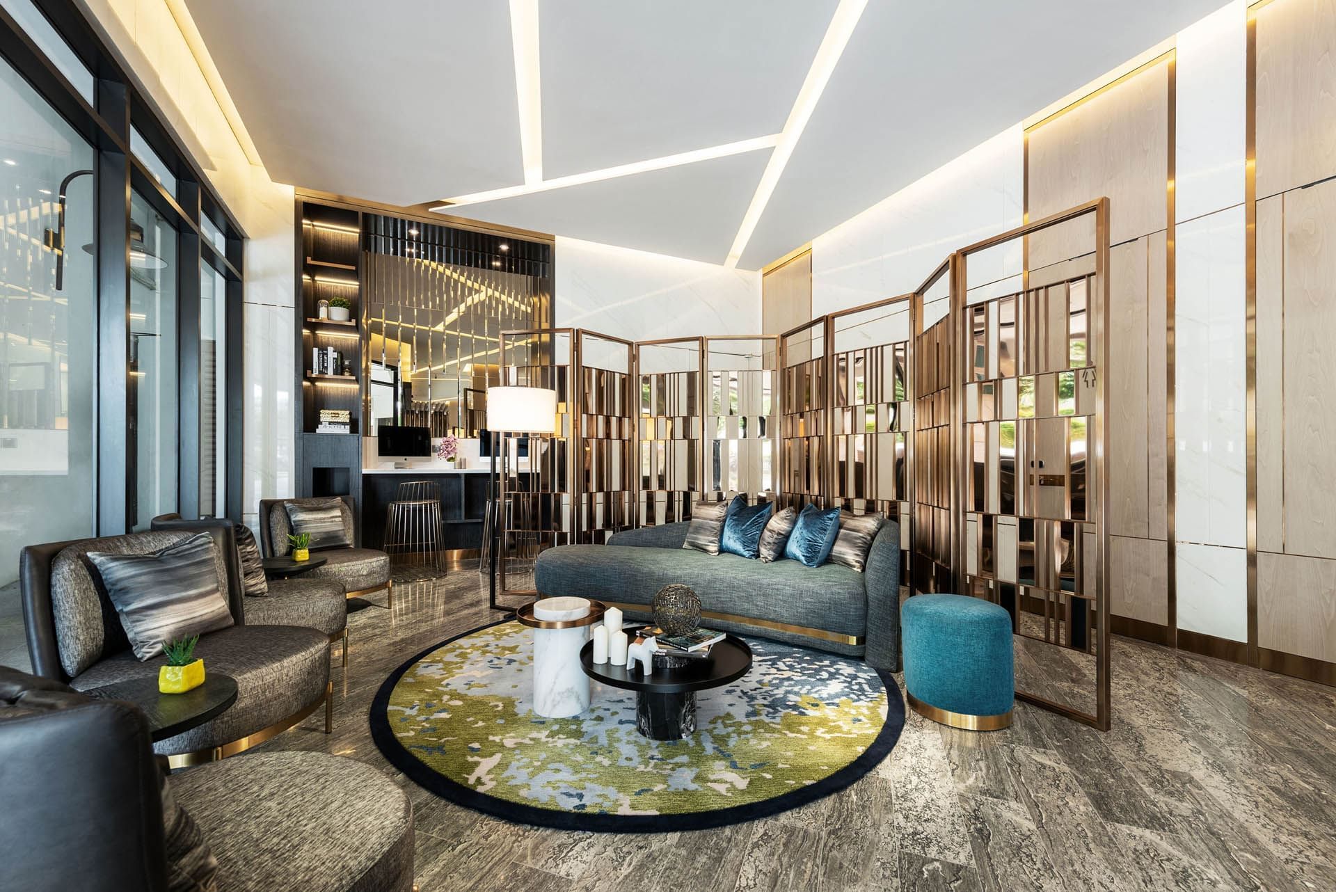 Image 103: Modern lobby with sleek furniture, circular rug, decorative partitions, and warm lighting at Orchard Grand Court