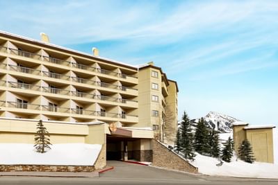 Front of Elevation Resort & Spa hotel in winter with snow on the ground and a mountain view
