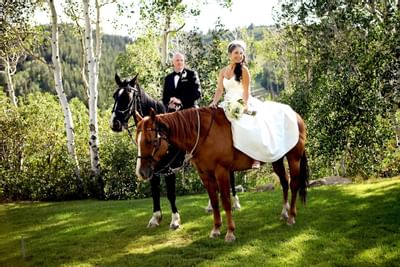 A bride riding on a horse at Stein Eriksen Lodge