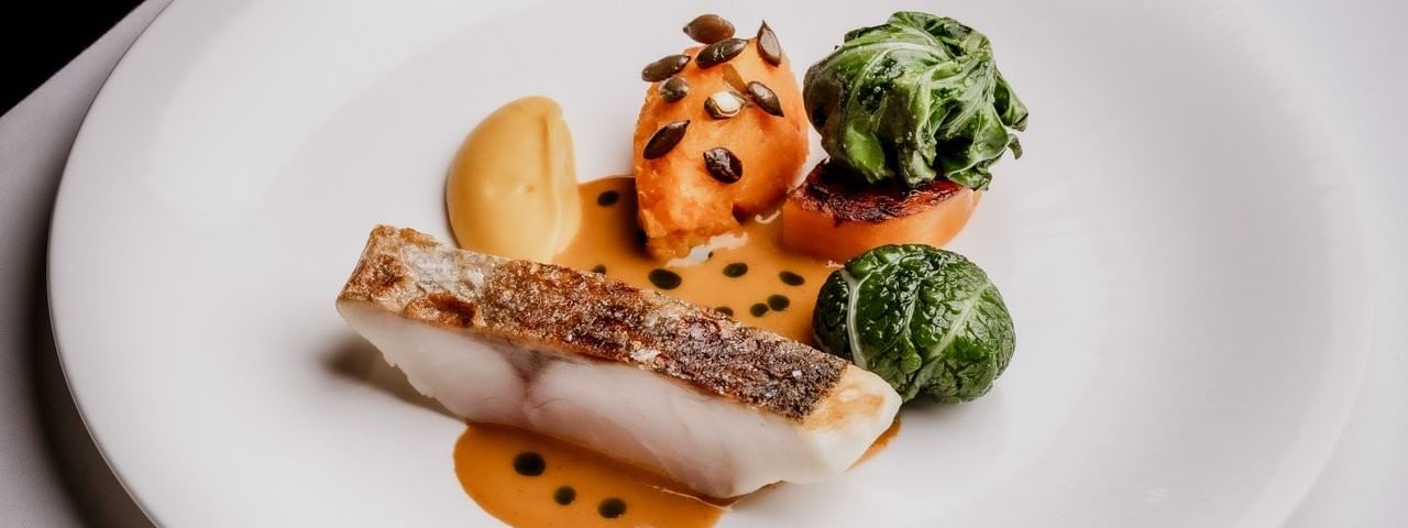 Pan-seared fish fillet with vegetables served in Tom Brown at The Capital at The Capital Hotel, Apartments and Townhouse