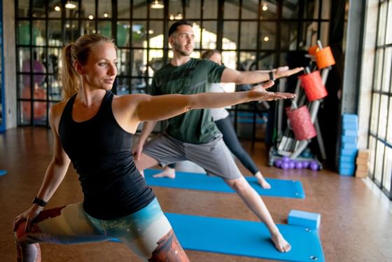 People doing yoga activities indoors at The Magnolia Hotel 