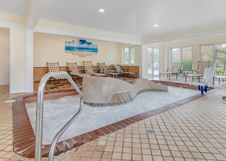 Serene spa setting with hot tub & lounge chairs in Day Spa at Meadowmere Resort