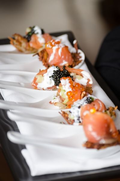 Close-up of smoked salmon and caviar served elegantly at The Stanley Hotel