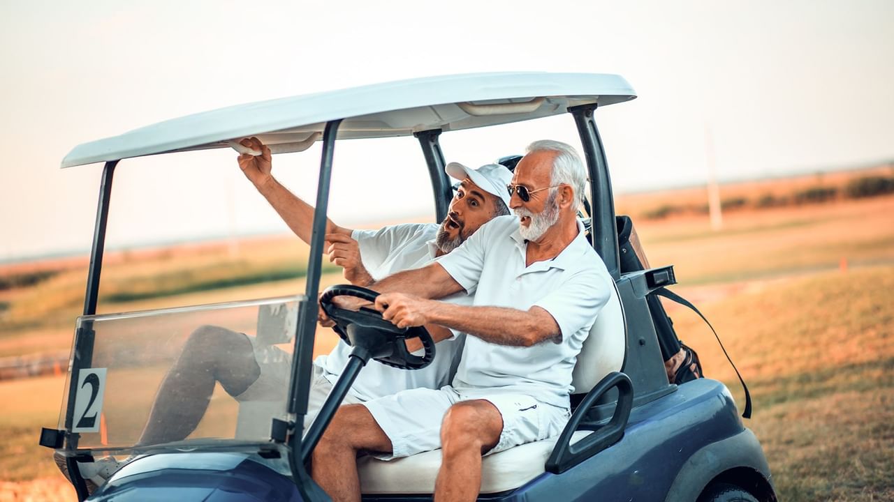 two golfers in a golf cart