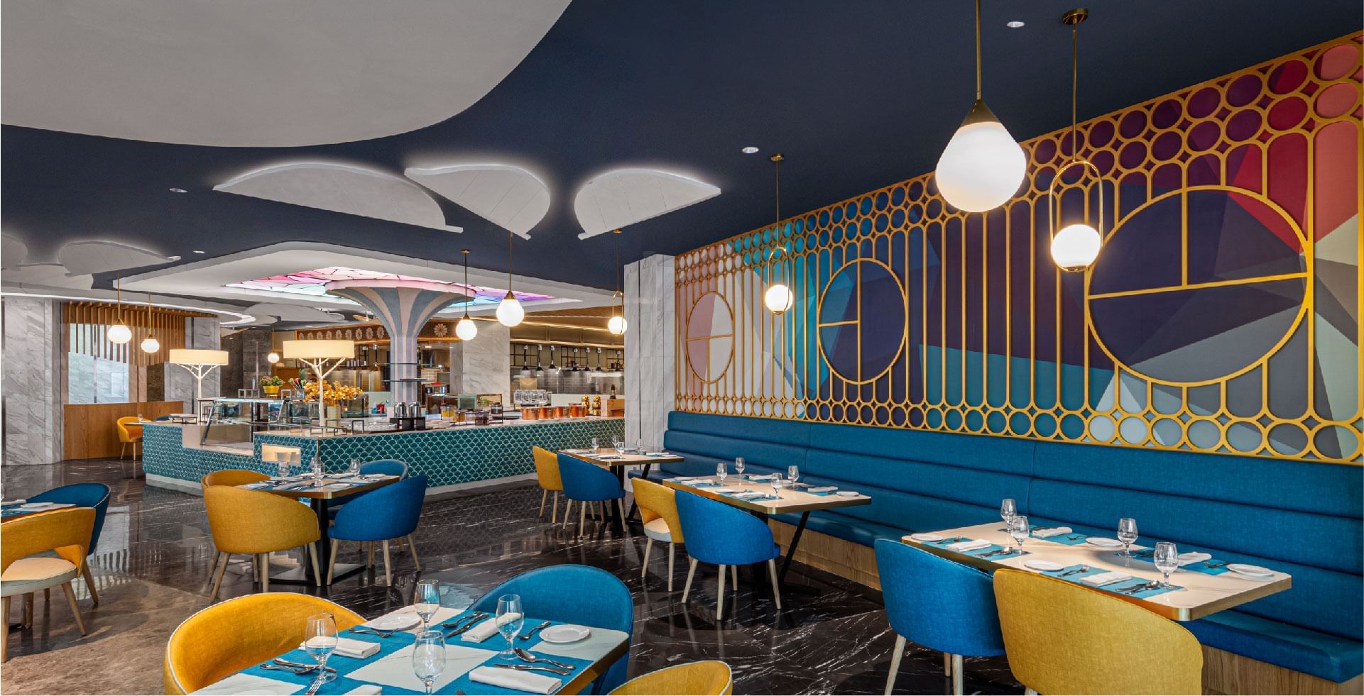 Vibrant and modern restaurant interior at Sunway Lagoon Hotel, with colorful seating and geometric wall designs