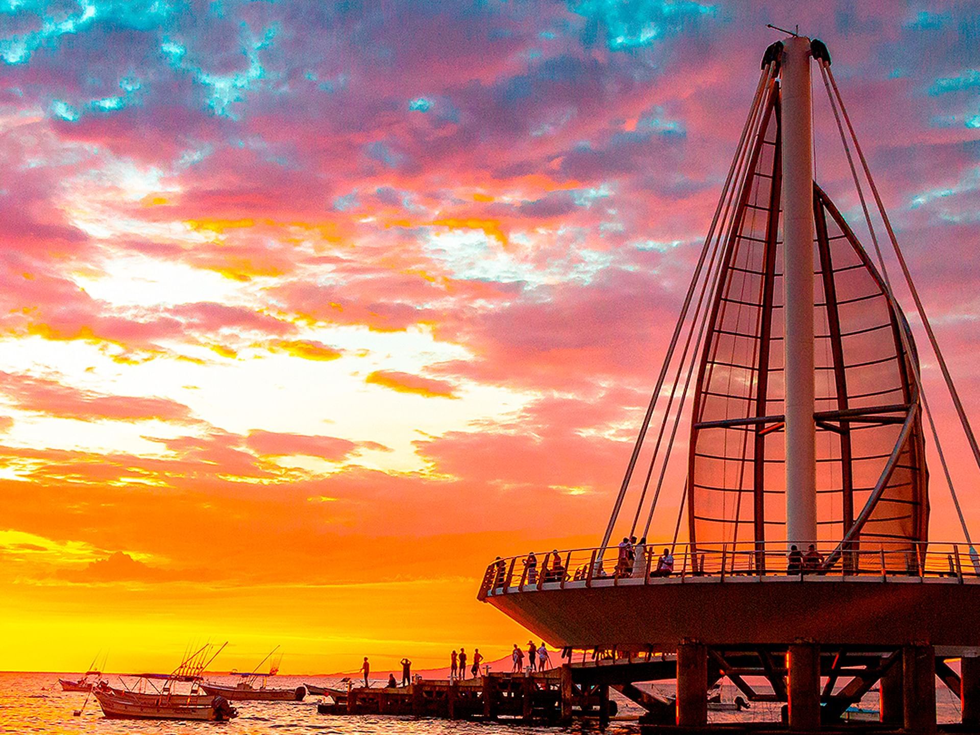 People in Los Muertos Pier at sunset near Los Arcos Suites