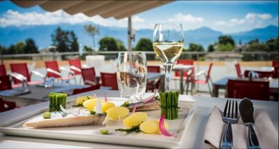 Fine dining setup with a fish dish and wine glass at Starling Hotels in Lausanne Switzerland