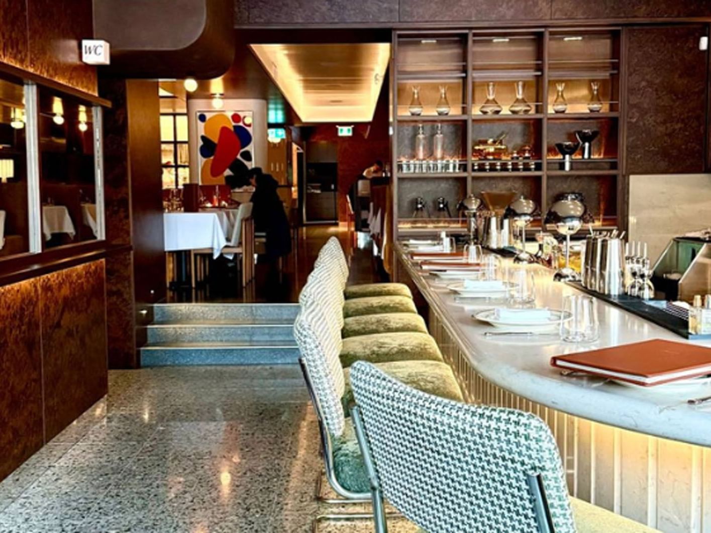 Linny's restaurant with bar seating and a person in the dining area near Hotel X Toronto